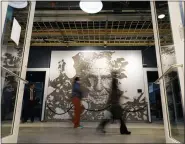  ?? REBECCA BLACKWELL/THE ASSOCIATED PRESS ?? People walk past a mural depicting former Miami Dolphins football coach Don Shula inside Hard Rock Stadium in Miami Gardens, Fla., on Sunday, Oct. 16.