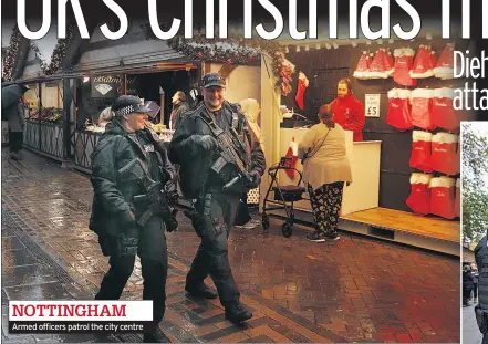  ??  ?? Armed officers patrol the city centre