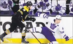  ?? Charles Krupa / Associated Press ?? Toronto’s Tyler Bozak, right, hits the ice on a check by Boston’s Jake DeBrusk during the second period on Wednesday.