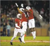  ?? EZRA SHAW — GETTY IMAGES ?? Curtis Robinson, middle, celebrates with Stanford teammates Alameen Murphy (4) and Frank Buncom (5) after Robinson intercepte­d a pass against Notre Dame on Saturday.