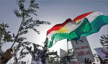  ?? SAFIN HAMED/AFP ?? Syrian Kurds hold posters and olive branches during a demonstrat­ion outside of the UN office in the northern Iraqi city of Arbil, the capital of the autonomous Kurdistan region, against a military operation by the Turkish army against the Kurdish YPG...
