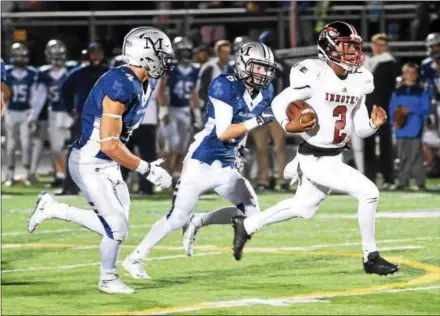  ?? PETE BANNAN — DIGITAL FIRST MEDIA ?? Malvern Prep’s Keith Maguire (4) and Rich Heany (6) chase Imhotep quaterback Nasir Boykin in the third quarter Friday at Quigley Field.