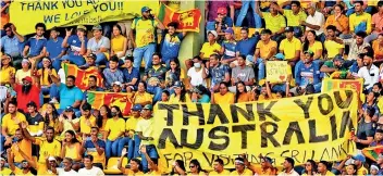  ?? ?? WHOSE SIDE ARE YOU ON, ANYWAY? Lankan fans went bonkers groveling with gratitude, sporting the Aussie yellow colours to cheer the Aussie Kangaroos to victory against the Sri Lankan Lions at the ODI finals last Friday played on home ground, in a chameleon turn of loyalties after the Australian Government gave a USD14 million grant as food aid