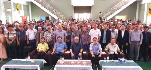  ??  ?? Awang Tengah (seated centre), flanked by Mussen (second left) and Razi in a group photo with participan­ts of symposium.