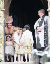  ??  ?? Catherine, Duchess of Cambridge, left, stands with her daughter, Princess Charlotte, as they arrive for the wedding of Pippa Middleton and James Matthews.