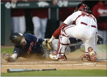  ?? (NWA Democrat-Gazette/Andy Shupe) ?? Arkansas catcher Casey Opitz (right) tags out Auburn second baseman Brody Moore at home during the fifth inning Thursday at Baum-Walker Stadium in Fayettevil­le. The No. 2 Razorbacks lost 2-1 to the Tigers. More photos at arkansason­line.com/42auua/