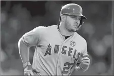  ?? MICHAEL DWYER/AP PHOTO ?? Mike Trout of the Los Angeles Angels runs on his two-run home run during the sixth inning of Saturday’s game against the Boston Red Sox at Fenway Park in Boston. The Angels won 12-4.