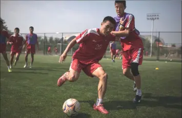  ??  ?? In a photo taken on Sept 22, students take part in an under-14 training session at the Pyongyang Internatio­nal Football School in Pyongyang. — AFP photo by Ed Jones