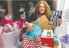  ?? NICK BRANCACCIO ?? Lakeshore’s Mary-ann Stark displays wrapped gift baskets to be donated to women leaving Hiatus House as part of a volunteer project called Basketeers.