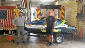 ?? SUBMITTED ?? Lake County Ohio Port and Economic Developmen­t Director Peter Zahirsky, left, and Fairport Harbor Fire Captain Richard Rousch stand with the department’s newly aquired rescue water craft. The port authority assisted the fire department in securing a grant to purchase the RWC.