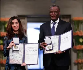  ?? haakon MosVoLD Larsen / nTB scanPIx VIa aP ?? The Peace Prize laureates Dr. Denis Mukwege from Congo and Nadia Murad from Iraq (left) pose with their medals during the Nobel Peace Prize Ceremony in Oslo Town Hall, Oslo, on Monday.