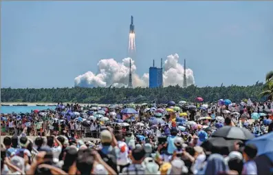  ?? LI GANG / XINHUA ?? A Long March-5B carrier rocket carrying the Wentian lab module blasts off from the Wenchang Spacecraft Launch Site in South China’s Hainan province on Sunday.