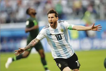  ??  ?? Argentina’s Lionel Messi celebrates after scoring his team’s opening goal during Tuesday’s World Cup match against Nigeria in St. Petersburg, Russia. Marcos Rojo scored in the 86th minute as Argentina advanced to the Round of 16 with a 2-1 victory....