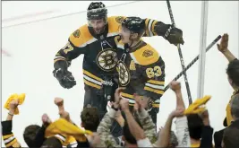  ?? STEVEN SENNE — THE ASSOCIATED PRESS ?? Boston’s Patrice Bergeron, left, celebrates with Brad Marchand after Marchand scored during the third period of Sunday’s Game 4. Marchand posted a five-point game in the win.