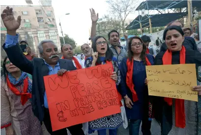  ??  ?? People hold signs and chant slogans to condemn the Thursday’s suicide blast at the shrine of Sufi saint Lal Shahbaz Qalandar in Sehwan Sharif, during a demonstrat­ion in Karachi on Saturday. —