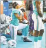 ?? Charles Trainor Jr. / TNS ?? Dolphins receivers Kenny Stills and Albert Wilson kneel during the national anthem before Thursday’s game against the Buccaneers at Hard Rock Stadium in Miami Gardens, Fla.
