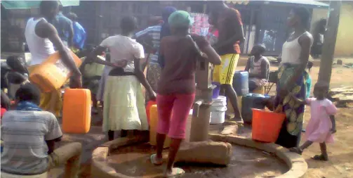  ??  ?? Men, women
and children
at a general pump in
Kakuri, Kaduna, waiting to fetch
water.