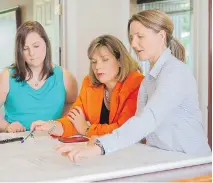  ??  ?? Annie Lemieux, president of LSR GesDev, examines blueprints with two members of her team: Alexandra Séguin-Harbec (at left), a junior engineer with LSR, and Lucie Laliberté (at right), vice-president of LSR.