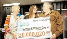  ??  ?? Andrea, centre, and Bill Groner get a cheque this week from Susan Green, of the Alberta Gaming and Liquor Commission.