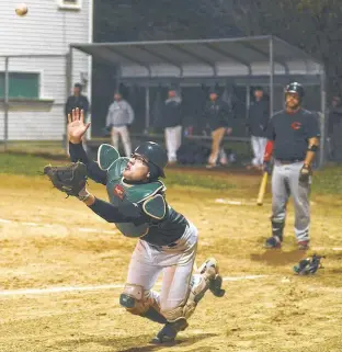  ?? FILE ?? Stratford Athletics’ catcher Grant Grady dives for a foul ball during the 2019 Kings County Baseball League playoffs.