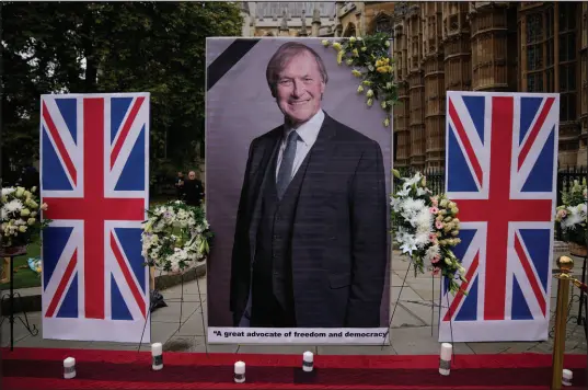  ?? Matt Dunham The Associated Press ?? An image of late British Member of Parliament David Amess is displayed Monday opposite the Houses of Parliament in London.