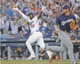  ?? JAE HONG ASSOCIATED PRESS ?? The Dodgers’ Yasiel Puig reacts after hitting an RBI single during Wednesday’s game.