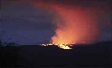  ?? CHELSEA JENSEN — WEST HAWAII TODAY ?? Lava pours out of the summit crater of Mauna Loa about 6:35a.m. Monday, as seen from Gilbert Kahele Recreation Area on Maunakea, Hawaii.