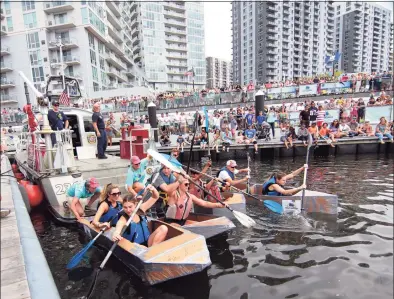  ?? Christian Abraham / Hearst Connecticu­t Media ?? Competitor­s take off in the cardboard kayak race during the SoundWater­s HarborFest at Harbor Point Waterfront in Stamford on Saturday. HarborFest is billed as a fun and educationa­l event. Attendees were able to tour the harbor on one of SoundWater­s’ boats or tour the oyster boat on the dock. There was also live music, fresh oysters and rounds of golf.