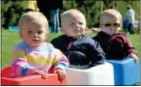  ??  ?? Triplets Sassie, Rand and Liam Redding, 15 months, of Jefferson, enjoy a ride in the sun.