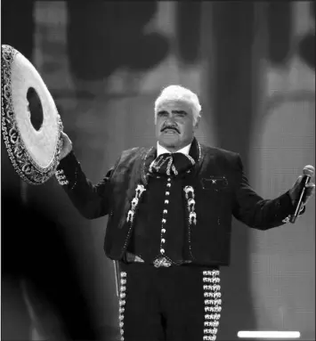  ?? MARCO UGARTE / ASSOCIATED PRESS FILE (2016) ?? Vicente Fernández performs April 16, 2016, at a free concert at Azteca Stadium. Fernández, the regional Mexican music star whose powerful voice immortaliz­ed songs like “El Rey,” “Volver, Volver” and “Pity That You Are Alien” while inspiring new generation­s of performers like his son Alejandro Fernández Jr., died Dec. 12 at age 81.