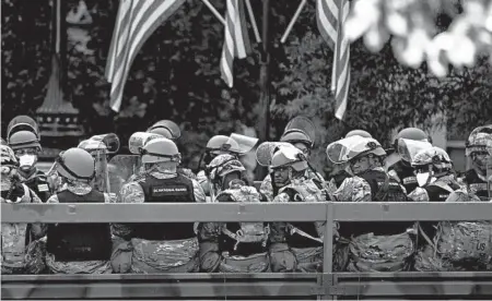  ?? CHIP SOMODEVILL­A/GETTY ?? A truck transports DC National Guard troops along West Executive Drive in support of law enforcemen­t officers Monday.