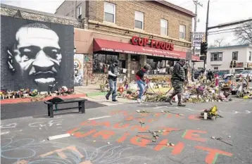  ?? JOHN MINCHILLO/AP ?? A memorial to George Floyd now includes a nod to Daunte Wright last week in Minneapoli­s. Within the last 11 months, both Black men died at the hands of police in Minnesota about 11 miles apart.