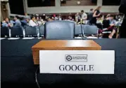  ??  ?? An empty chair reserved for Google’s parent Alphabet, which refused to send its top executive, is seen Wednesday as Facebook and Twitter executives testify before the Senate Intelligen­ce committee.