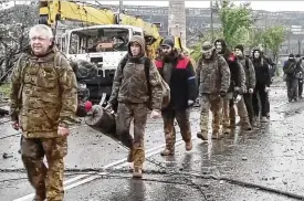  ?? RUSSIAN DEFENSE MINISTRY PRESS SERVICE VIA AP ?? This photo taken from video released by the Russian Defense Ministry on Thursday shows Ukrainian servicemen as they leave the besieged Azovstal steel plant in Mariupol, in territory under the government of the Donetsk People’s Republic, eastern Ukraine.