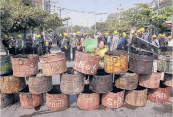  ?? AP ?? Protesters build barricades to deter Myanmar security personnel from entering an area Thursday in Mandalay. Demonstrat­ors protesting last month’s military coup returned to the streets Thursday, undaunted by the killing of 38 people the previous day.