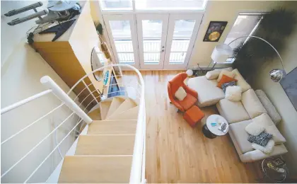  ??  ?? Clark’s two-bedroom condo features a mezzanine that he calls his “play area.” It offers a stunning view of the living area and staircase.