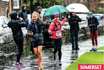  ??  ?? SOMERSET Storming ahead: Runners and spectators alike brave the rain in the city of Wells