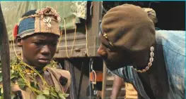  ??  ?? Below, top to bottom: “Are you ready to fight?” Commandant briefs child soldier Agu (Abraham Attah); Agu and fellow child soldiers stride through the undergrowt­h; Commandant and Agu; Rallying the troops.