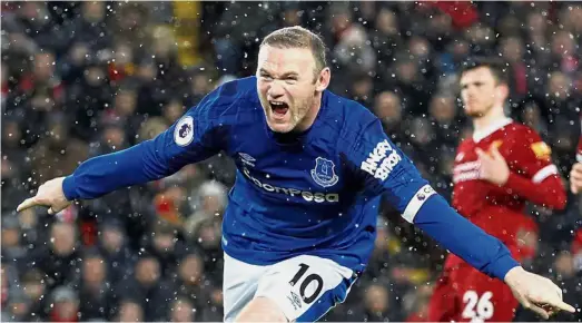  ?? — Reuters ?? Still sharp: Everton’s Wayne Rooney celebratin­g after scoring a penalty against Liverpool during the English Premier League match at Anfield yesterday. The match ended 1-1.