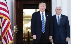  ??  ?? BEDMINSTER TOWNSHIP, New Jersey: US President-Elect Donald Trump (left) and Vice President-Elect Mike Pence arrive at the clubhouse at Trump Internatio­nal Golf Club yesterday. — AFP