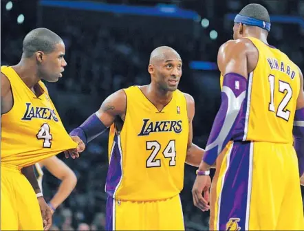  ?? Wally Skalij Los Angeles Times ?? IN HIS 17TH SEASON with the team, Kobe Bryant tries to bring together such first-year Lakers as Antawn Jamison, left, and Dwight Howard and lead them to a title. “Winning takes precedence over all,” Bryant says. “There’s no gray area. No almosts.”