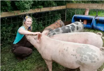  ??  ?? Bringing home the bacon: Mimi with her pigs