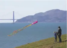  ?? Lea Suzuki / The Chronicle ?? It could be a good time to fly a kite, as Richmond’s Adam Gerardin did with daughter Nia, 6, in Berkeley in January.