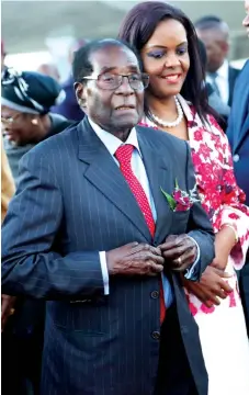  ?? Picture: Believe Nyakudjara ?? President Mugabe walks with First Lady Amai Grace Mugabe on arrival at Harare Internatio­nal Airport from Singapore yesterday morning.—