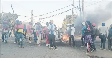  ?? (Pics: Nhlanganis­o Mkhonta) ?? Supporters of the jailed Members of Parliament dancing around the burning tryes in the middle of the road.