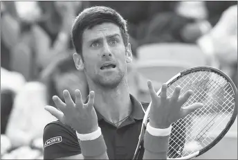  ?? AP PHOTO ?? Novak Djokovic reacts after missing a shot against Marco Cecchinato during their quarterfin­al match at the French Open tennis tournament.