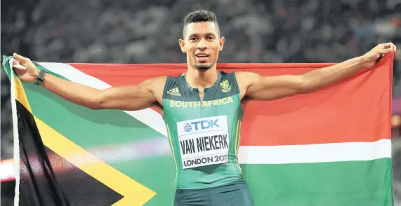  ?? PICTURE: EPA ?? ON TOP OF THE WORLD AGAIN: Wayde van Niekerk proudly displays the Rainbow Nation flag after winning the men’s 400m final at the IAAF World Championsh­ips in London.