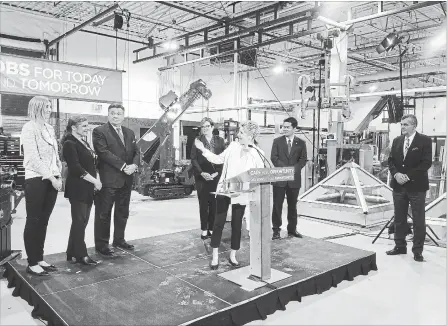  ?? ROBERT BENZIE/TORONTO STAR ?? Premier Kathleen Wynne and Finance Minister Charles Sousa, third from left, claim the NDP will end up cutting billions in program spending.