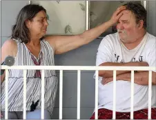  ??  ?? Josslin MacMenigal­l, 63, and her husband, Mike, 65, sit outside their mobile home that has no power in Rough and Ready on Wednesday.