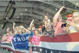  ?? SUSAN WALSH/AP ?? People wait for the arrival of President Donald Trump at his "Make America Great Again Rally" at Orlando-Melbourne Internatio­nal Airport on Saturday.